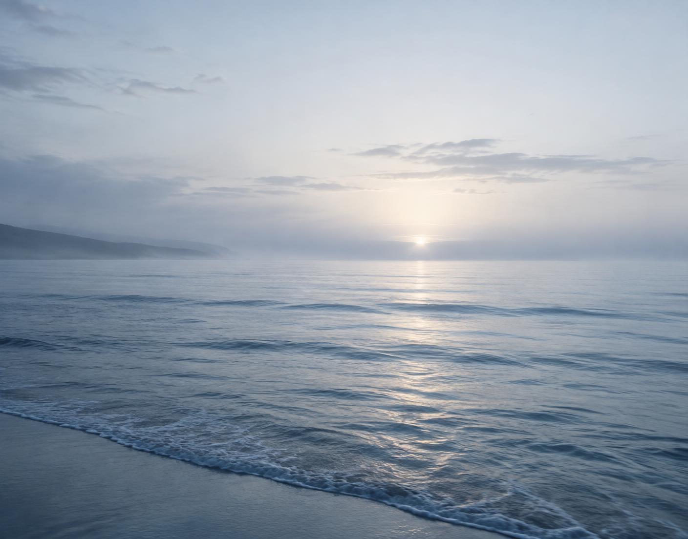 Soft morning light over a calm ocean at sunrise